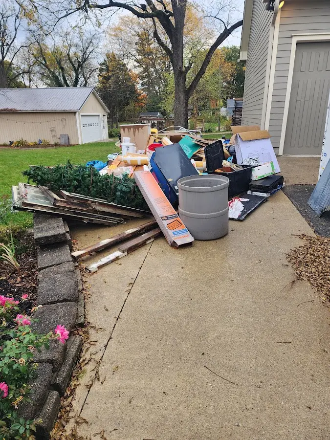 Dumpster being loaded with debris for 10 Yard Dumpster Rental in Hempstead